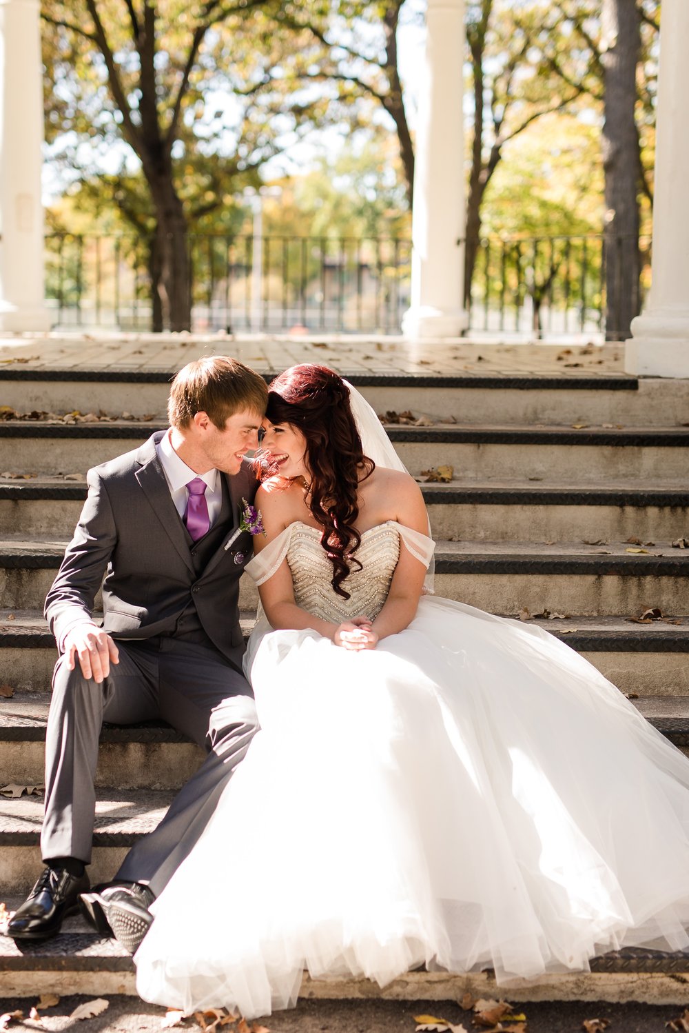 Downtown Fargo Disney Themed Wedding by Amber Langerud Photography | Bride & Groom Island Park sitting on steps