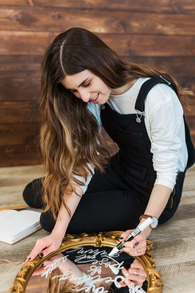 Branding Photography image of a calligrapher writing on a mirror