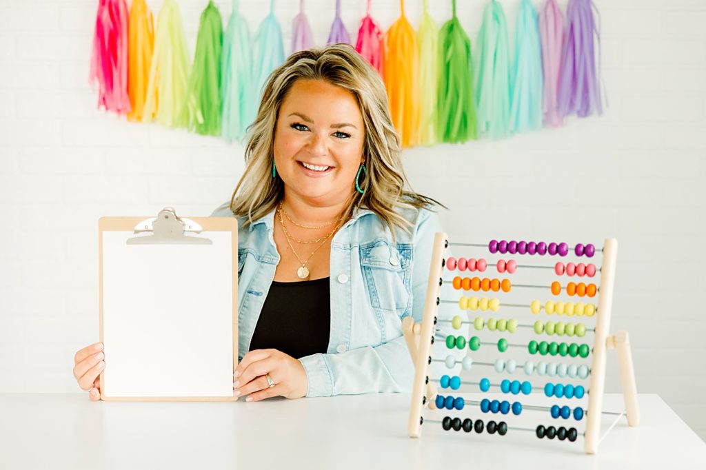 teacher influencer holding clipboard with rainbow bead counter
