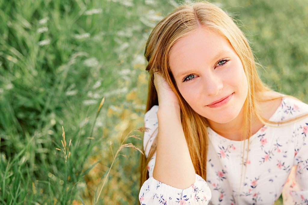 Hawley High School Senior Pictures girl sitting in grass wearing floral shirt