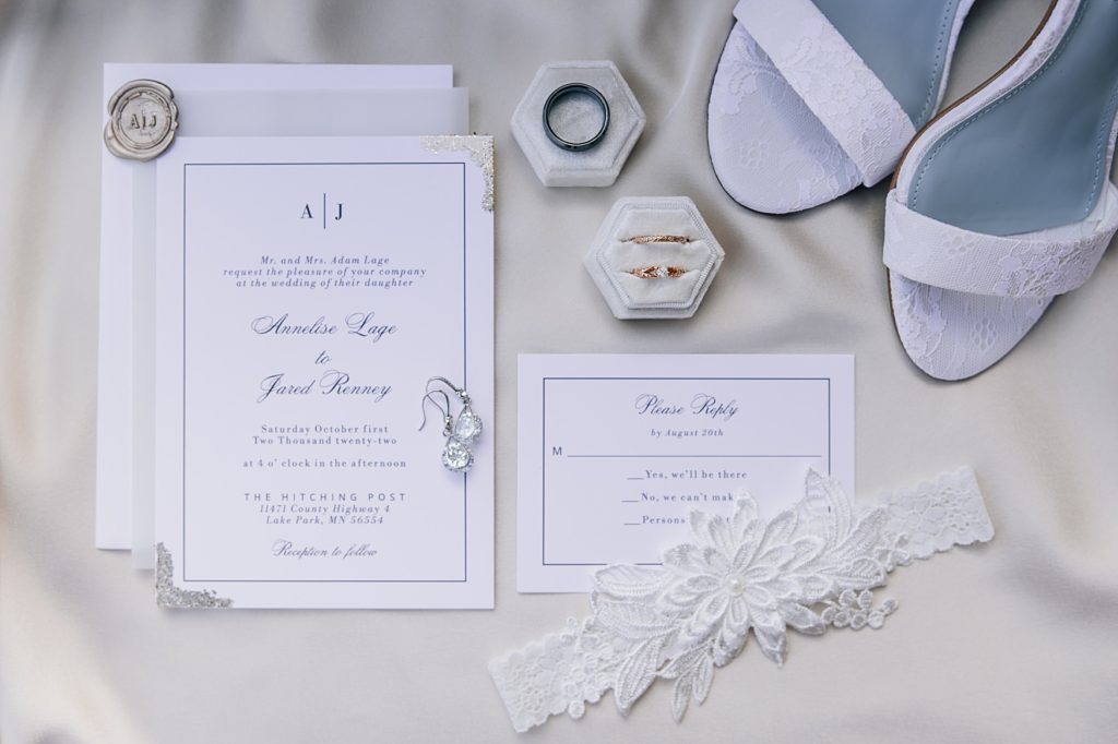 Wedding Details including invitation, rings, earrings, shoes and garter 
