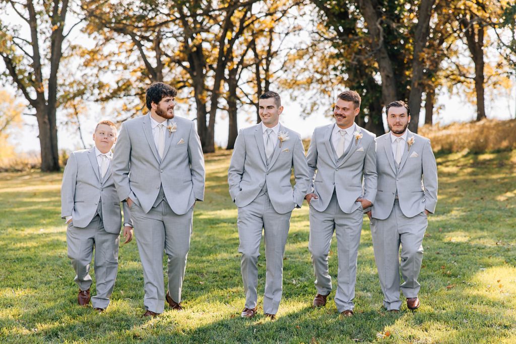Groomsmen casually walking on the lawn of the Hitching Post