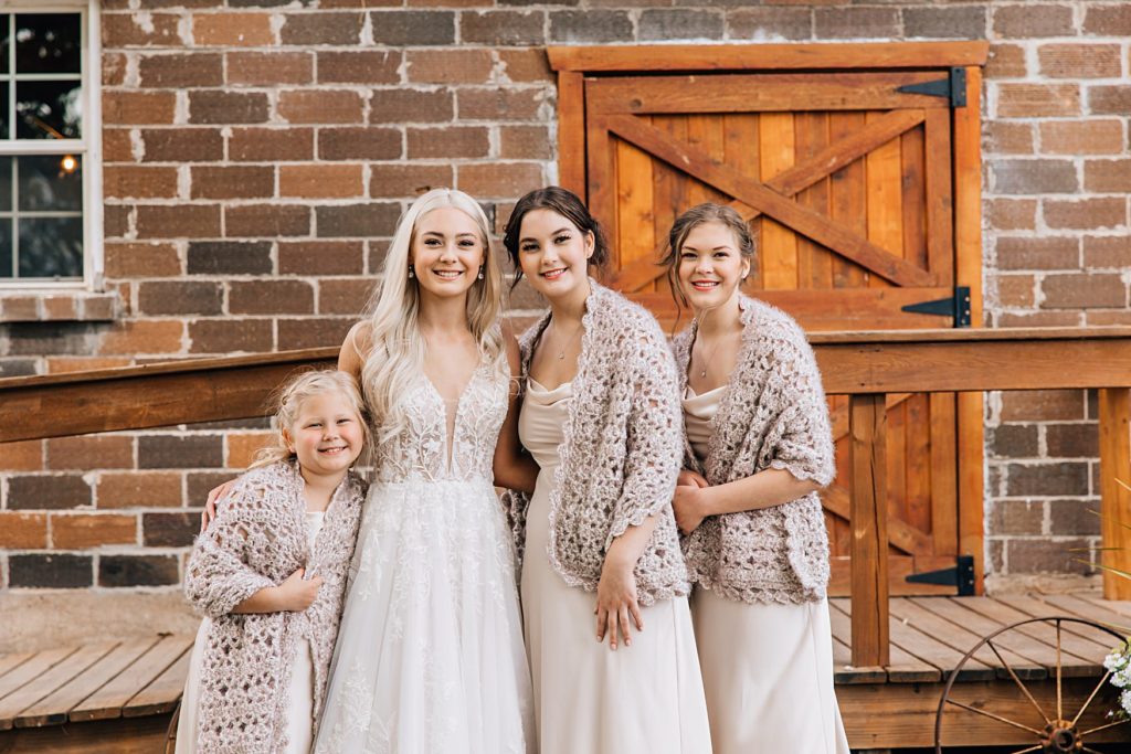 Bride with her sisters in front of the Barn at the Hitching Post MN