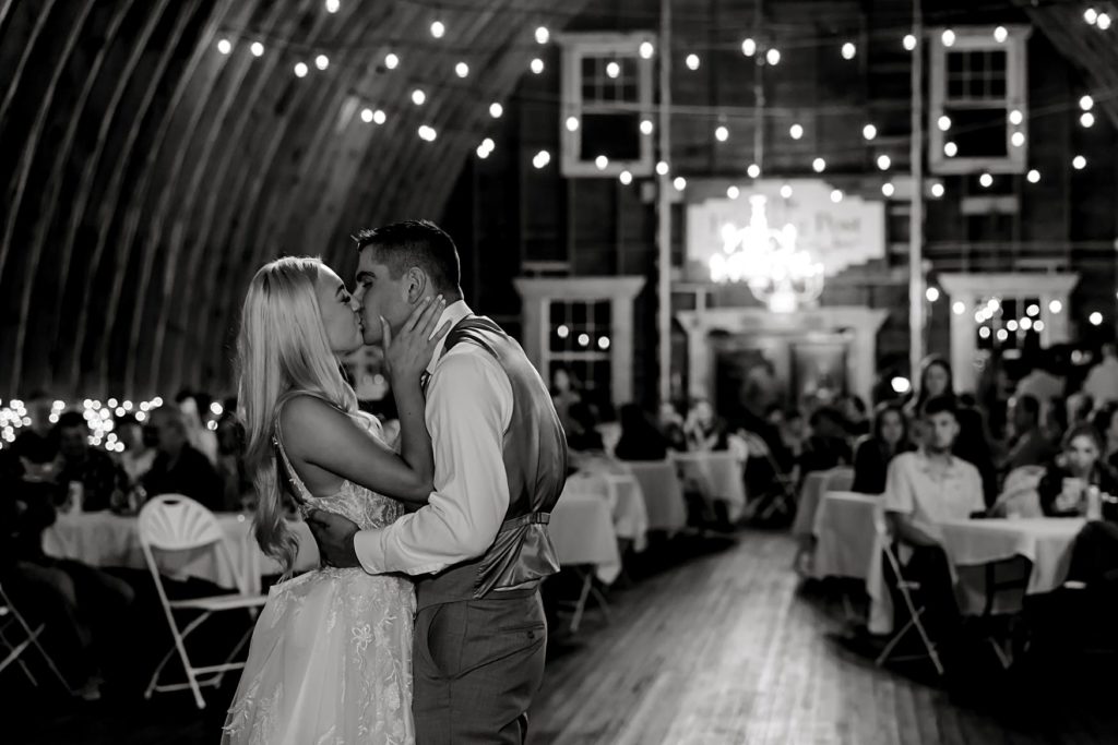 Bride and groom kiss on the dance floor