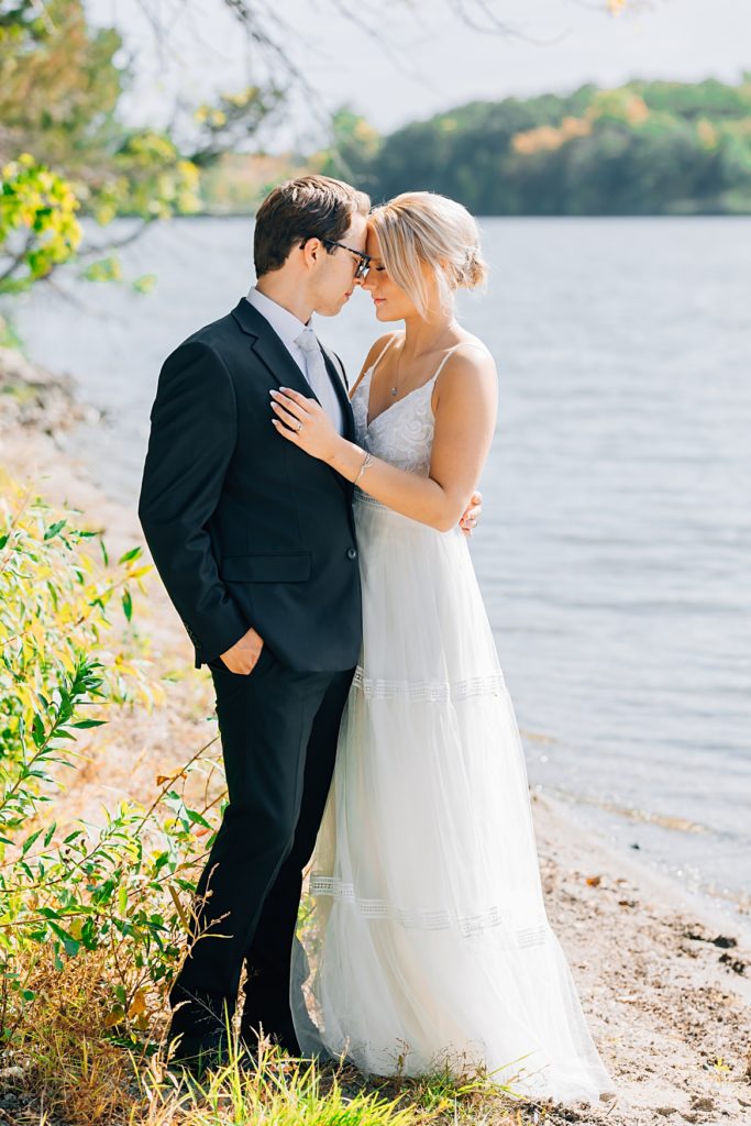 bride and groom by the lake at Willmar, MN Stonewall Farms Wedding