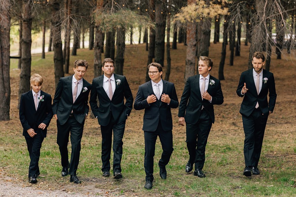 groomsmen walking at Willmar, MN Stonewall Farms Wedding