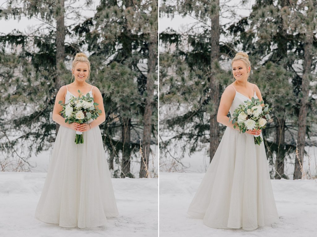 Bride posed in the snow in front of pine trees at the Timbers Event Center in Staples, MN