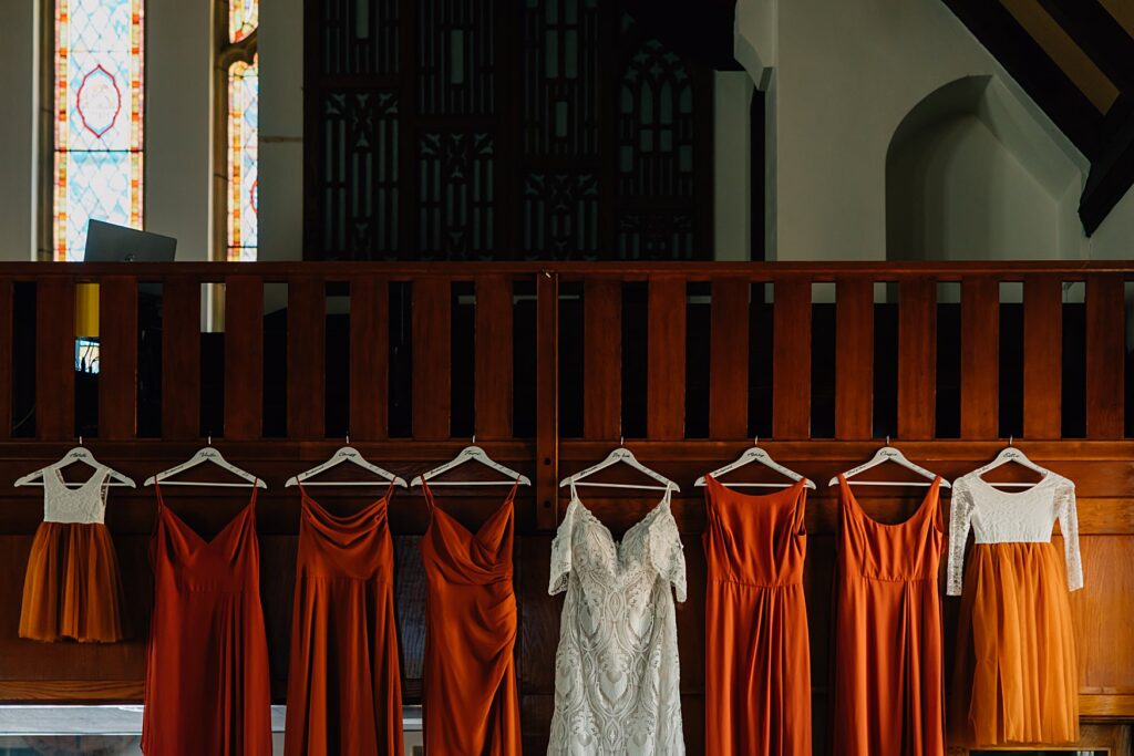 wedding dresses hanging in the church
