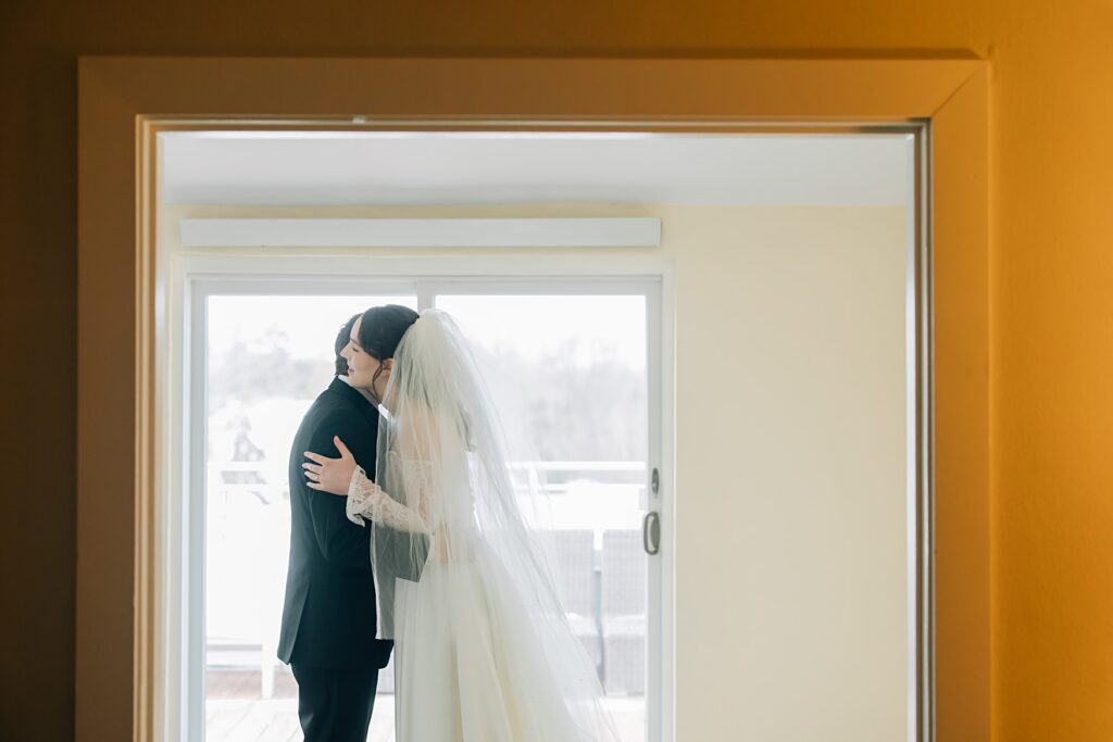 Bride and groom hugging at the Lafayette Club in Minnetonka Beach, MN