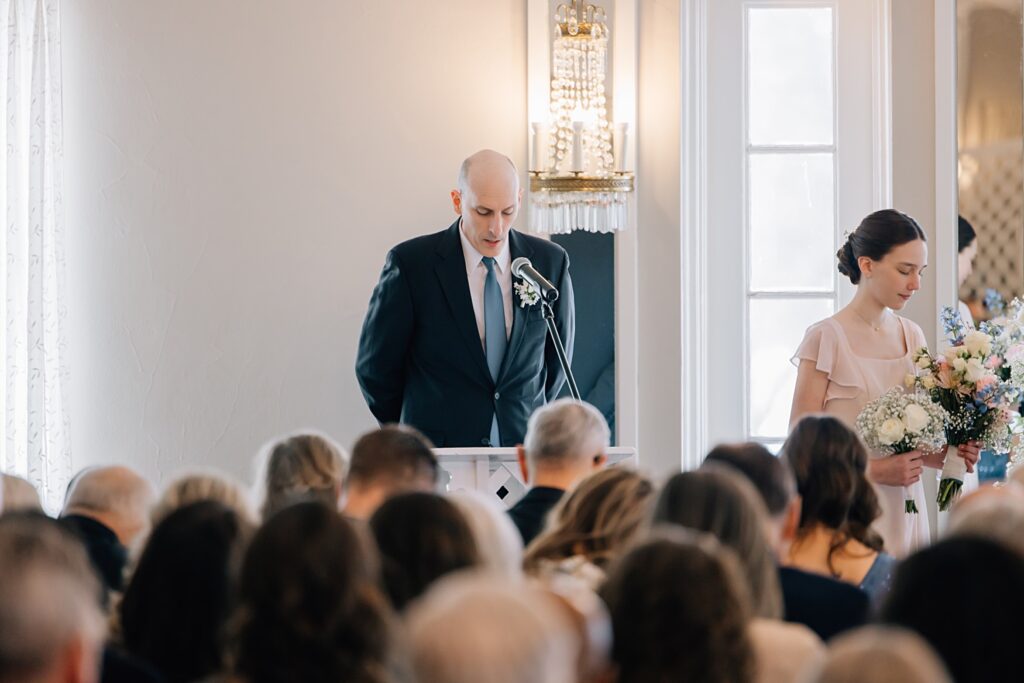 Opening prayer of wedding ceremony at the Lafayette Club in Minnetonka Beach, MN