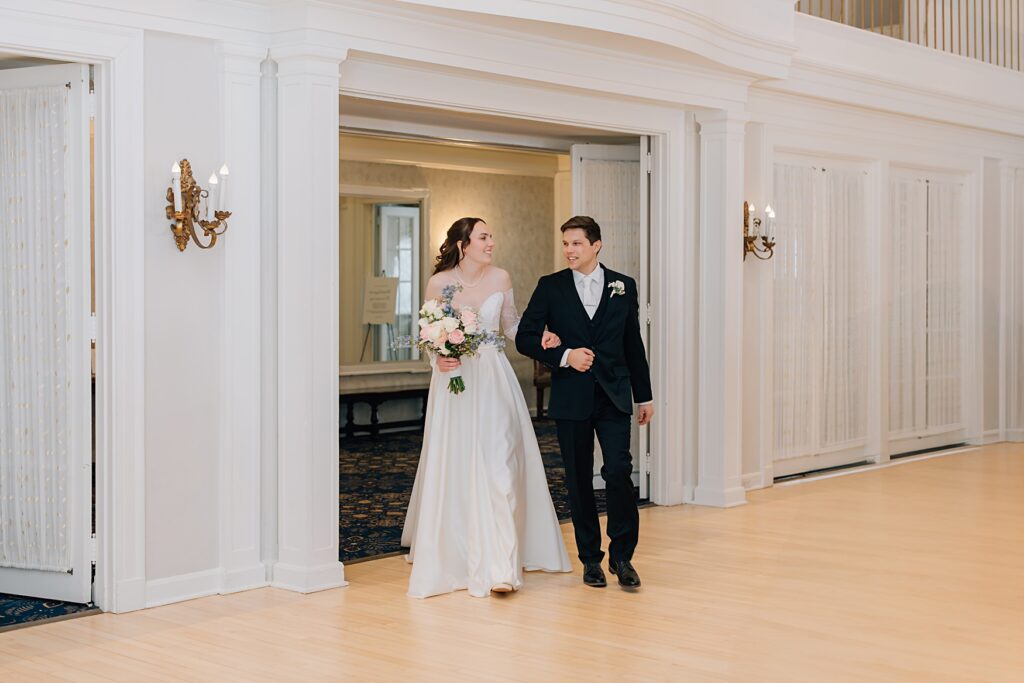 Bride and groom entering reception at the Lafayette Club in Minnetonka Beach, MN