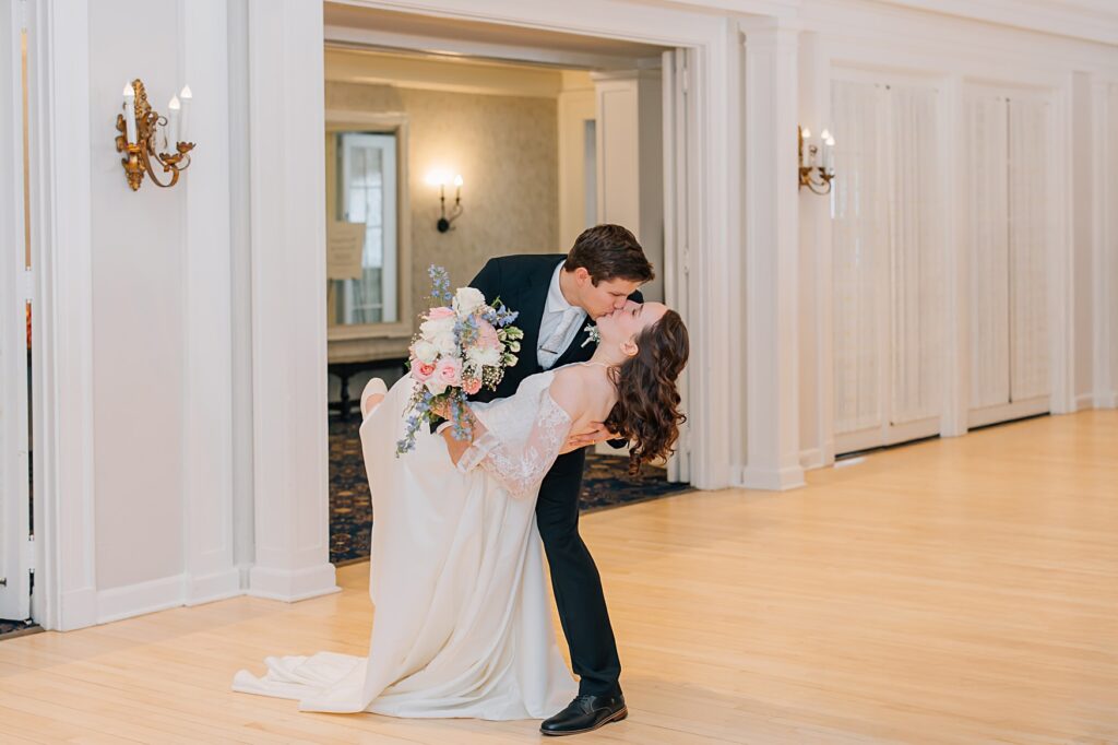 Groom dipping bride at the Lafayette Club in Minnetonka Beach, MN