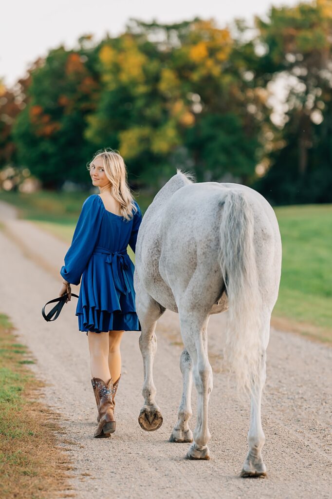 Senior Pictures with Your Horse | Senior and Horse walking away from the camera