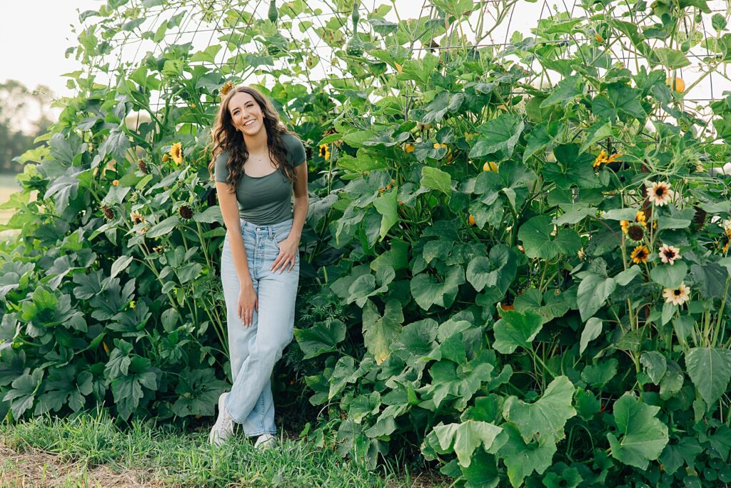Minnesota High School senior standing in front of sunflowers; ideas for planning your minnesota senior session