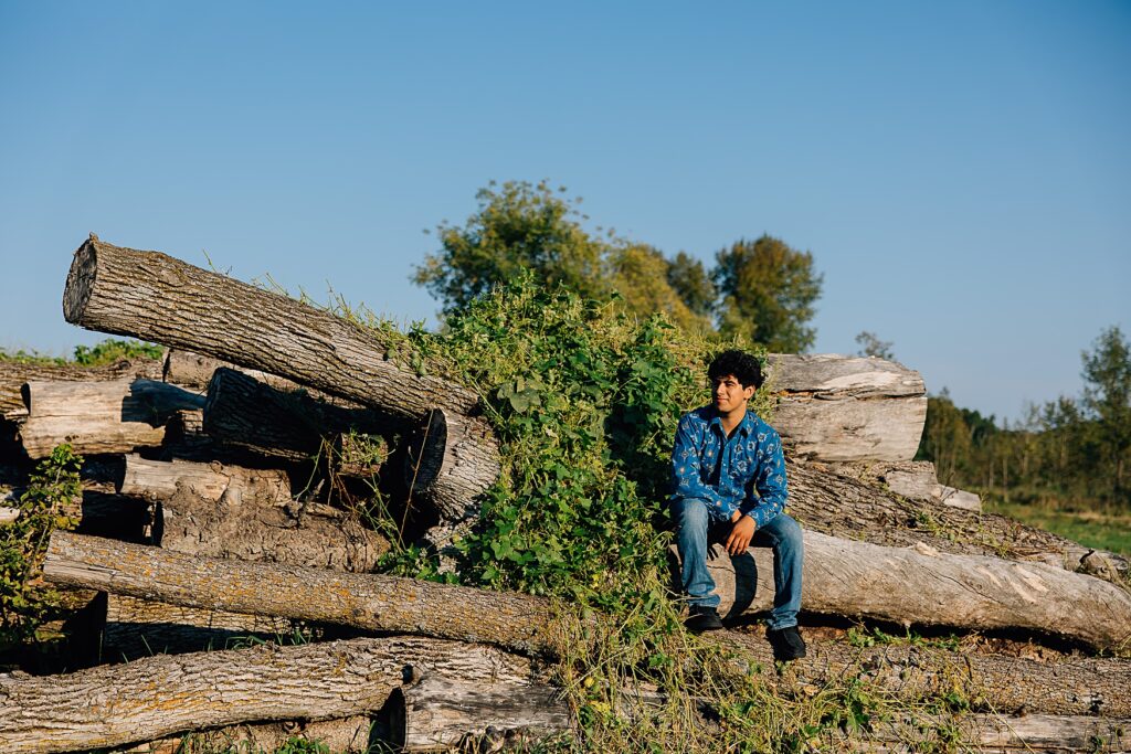 high school senior on log pile