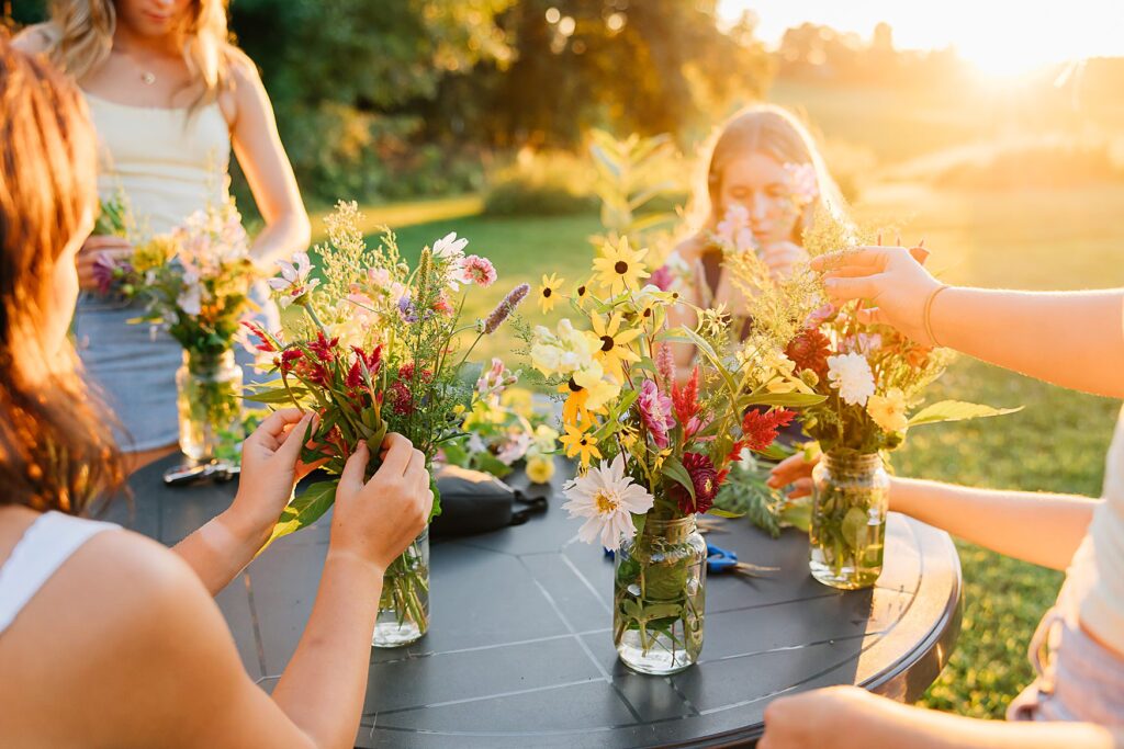 Group of friends arranging photos, branding photography for a UPick flower field.