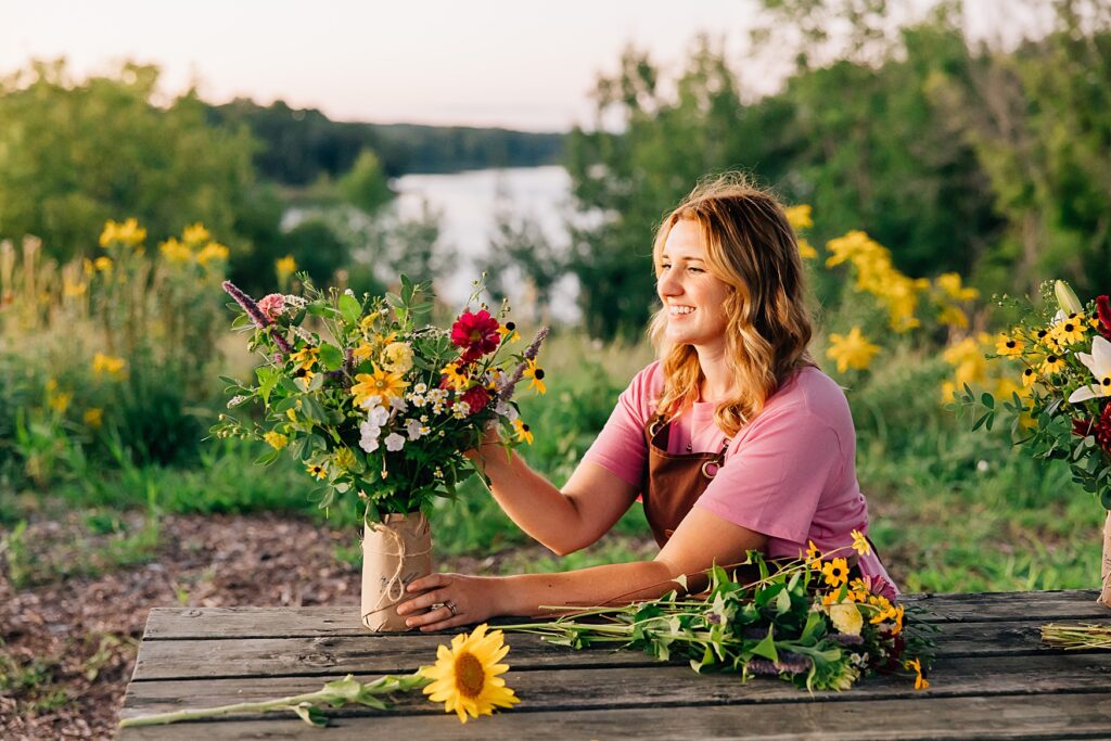 Flower farmer designing a bouquet using seasonal, locally grown blooms