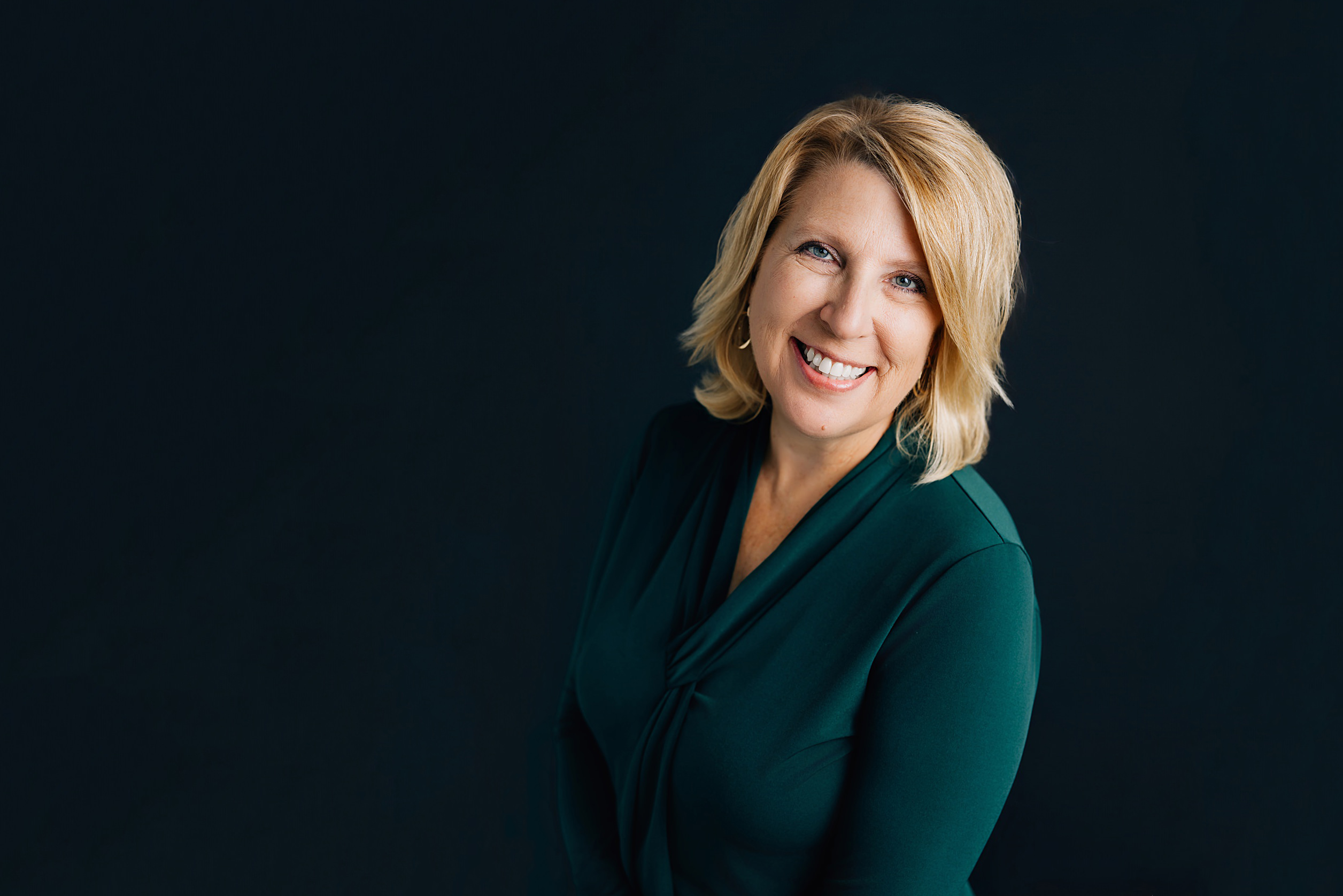 Monica McConkey of Eyes on the Horizon smiling during a professional brand photography session