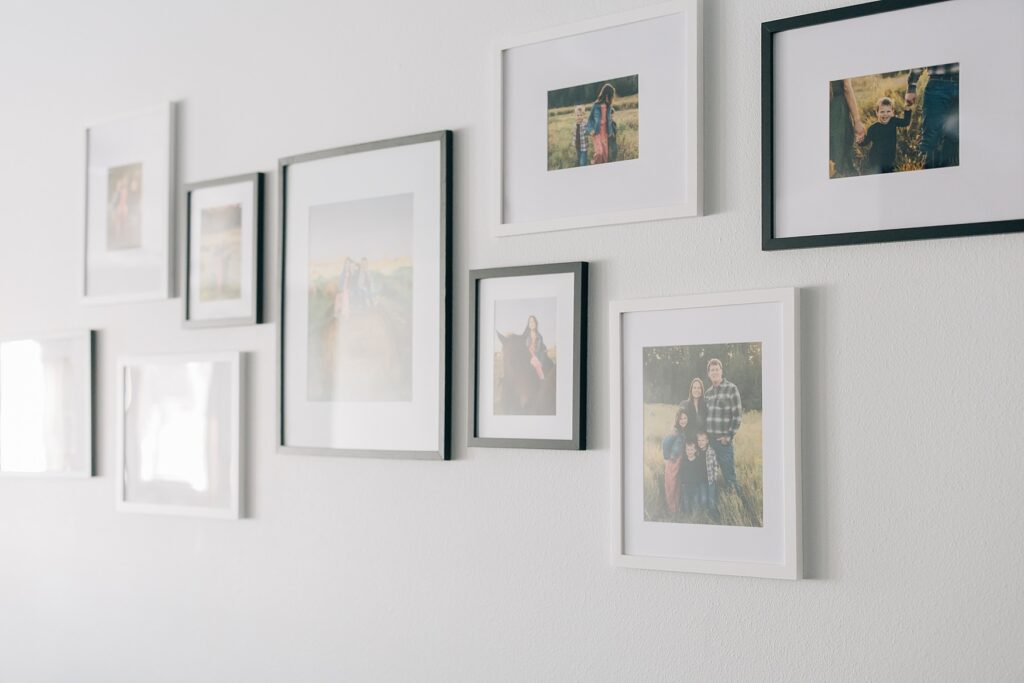 Inexpensive gallery wall with Amazon frames and professional photo prints arranged in an asymmetrical layout
