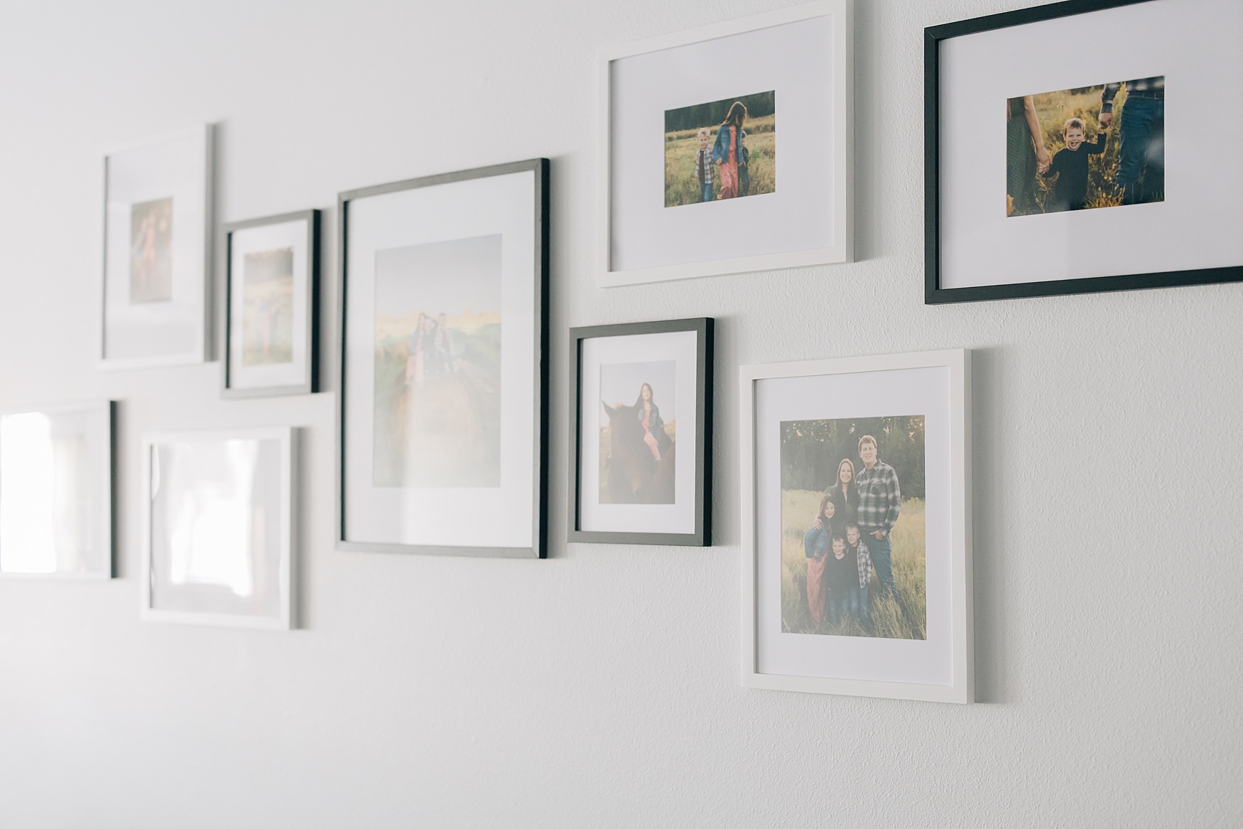 Inexpensive gallery wall with Amazon frames and professional photo prints arranged in an asymmetrical layout