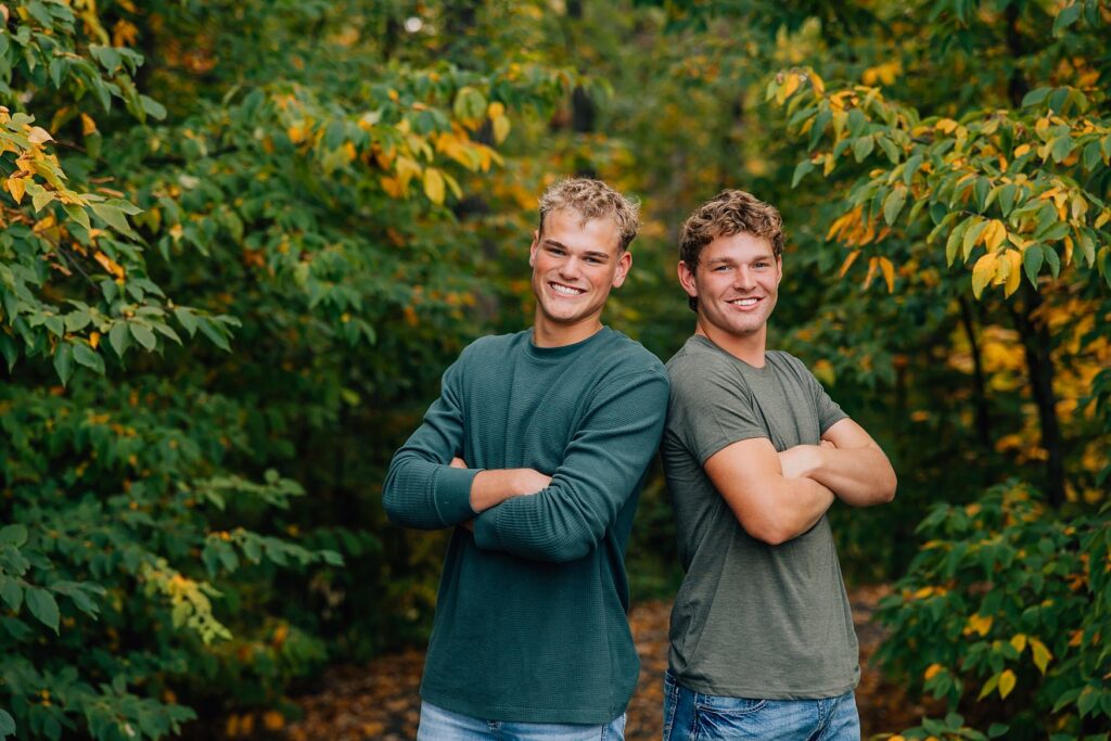 two guys standing back to back at sucker creek in Detroit Lakes, MN