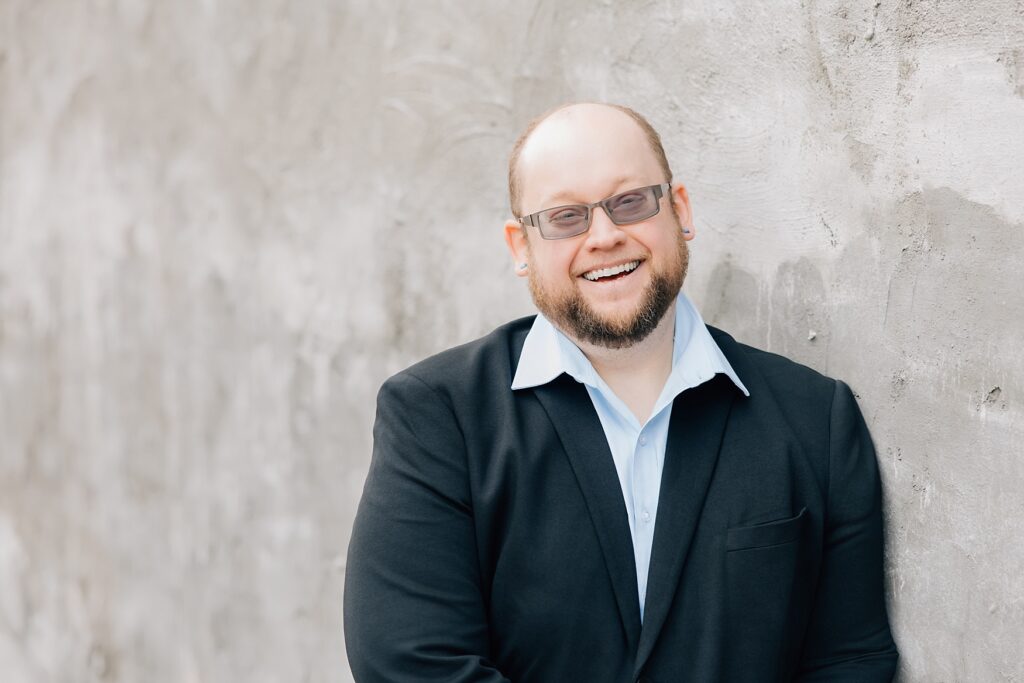 Downtown Detroit Lakes Lunch Break Headshot | guy leaning against wall